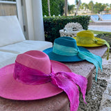 Colorful hand dyed toquilla straw sun hats with flowing ribbons and custom initials