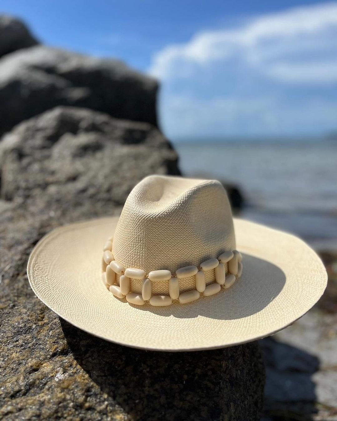 Beige toquilla straw hat with wooden band, ethically handcrafted and stylish for any occasion