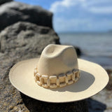 Beige toquilla straw hat with wooden band, ethically handcrafted and stylish for any occasion