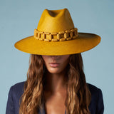 Handcrafted yellow toquilla straw Panama hat with a stylish wooden chain