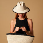 Woven toquilla straw hat and tote bag with black trim from the Paya - Packable collection