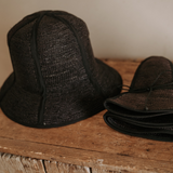 Black woven sun hats made from natural toquilla straw, perfect for stylish sun protection