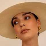 Woman in Ibiza - Wide Brim genuine Panama hat and gold hoop earrings showcasing style