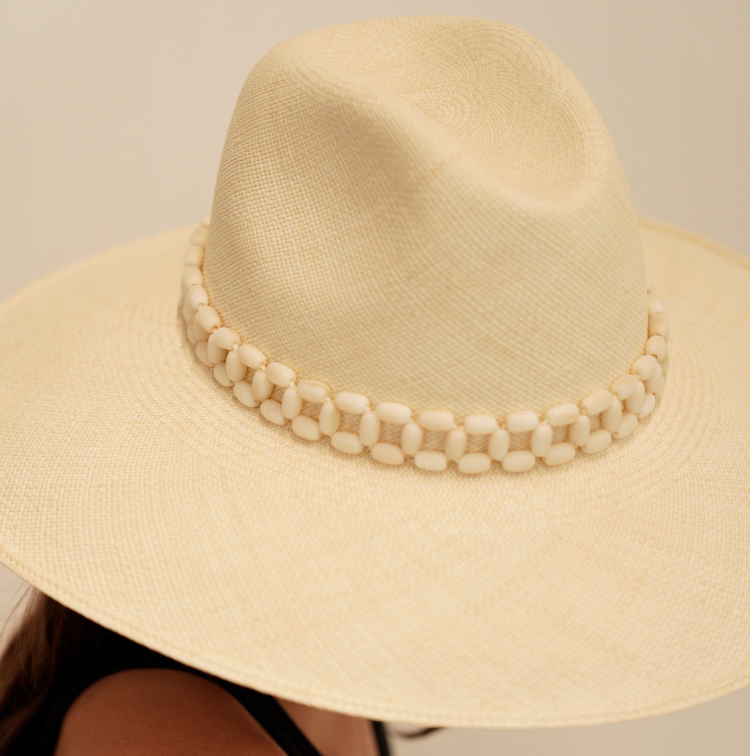 Wide-brimmed straw hat made of natural toquilla straw with a stylish beaded band