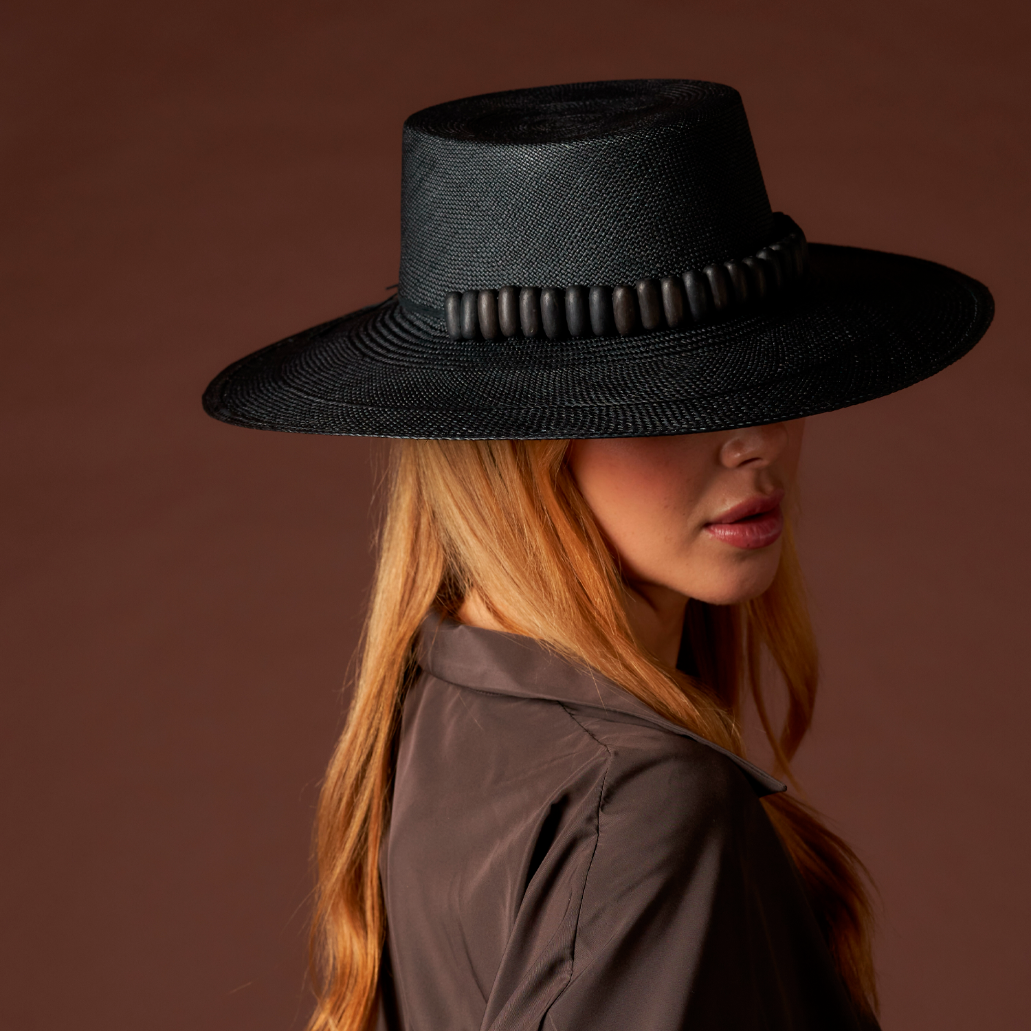 Black straw hat with beaded band featuring tagua nut beads in the Raku - Wide Brim