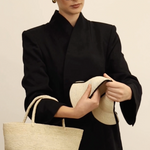 Woman in black blazer with natural Toquilla straw tote bag named Sandra - Foldable