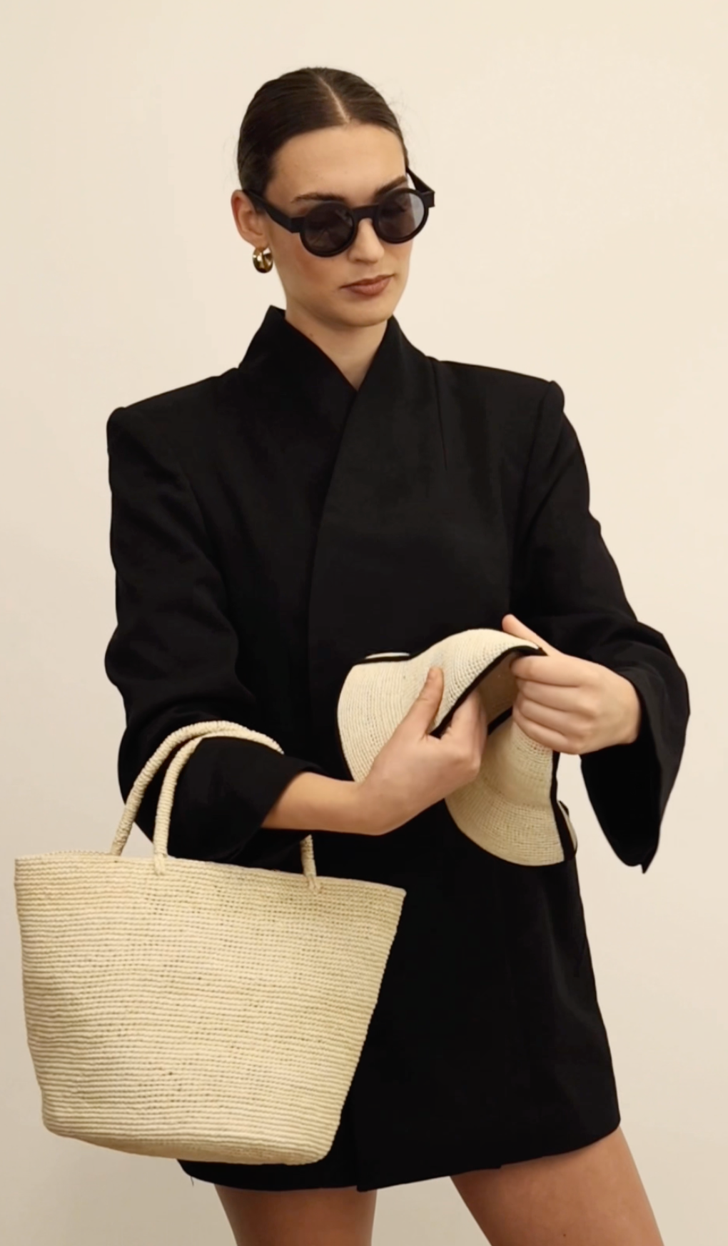 Woman in black blazer with natural Toquilla straw tote bag named Sandra - Foldable