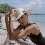 Wide-brimmed straw hat with black band made of natural Toquilla straw