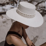 Wide-brimmed white hat with beaded band made of natural toquilla straw and tagua nut