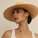 Wide-brimmed straw hat made from natural toquilla straw with a chin strap, Bromelia product