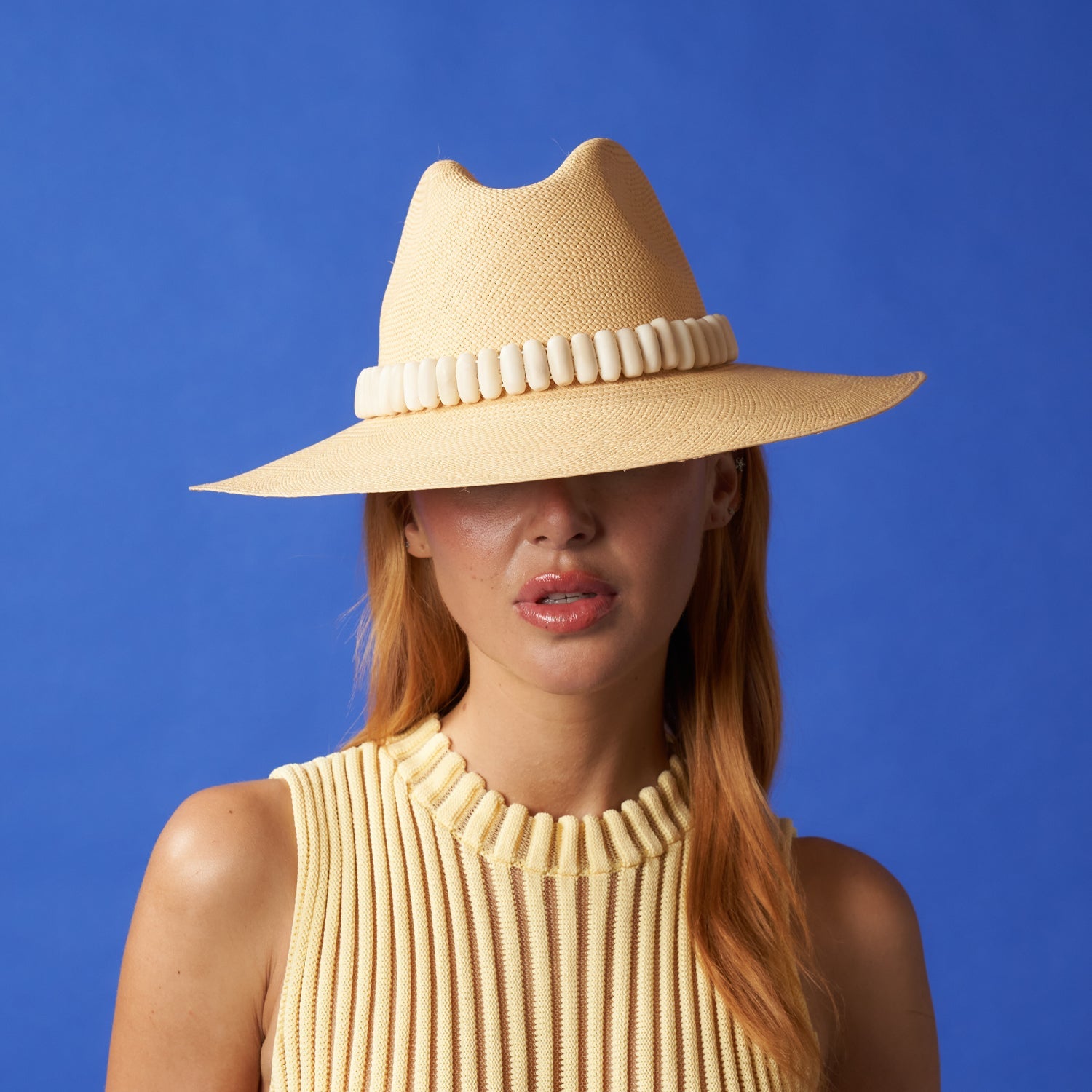 Woman in a Shayak Wide Brim hat made of toquilla straw and adorned with tagua nut