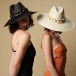 Two ethically handcrafted toquilla straw hats with decorative bands from Ine