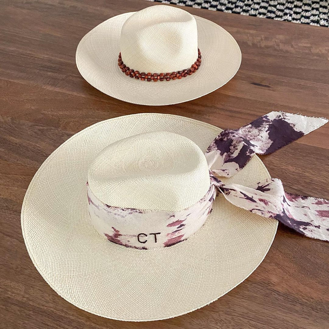 Two hand dyed toquilla straw hats with custom initials design
