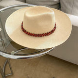 Beaded straw hat from Peoni featuring a wide brim and genuine Panama hat craftsmanship