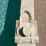 Woven Nativa tote bag with natural toquilla straw, hat, and decorative plates