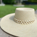 Beige Tulipan toquilla straw hat with a beaded band and tagua nut accents
