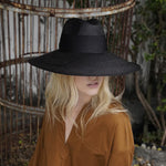 Wide-brimmed black straw hat made from sustainable Toquilla straw, Antibes design