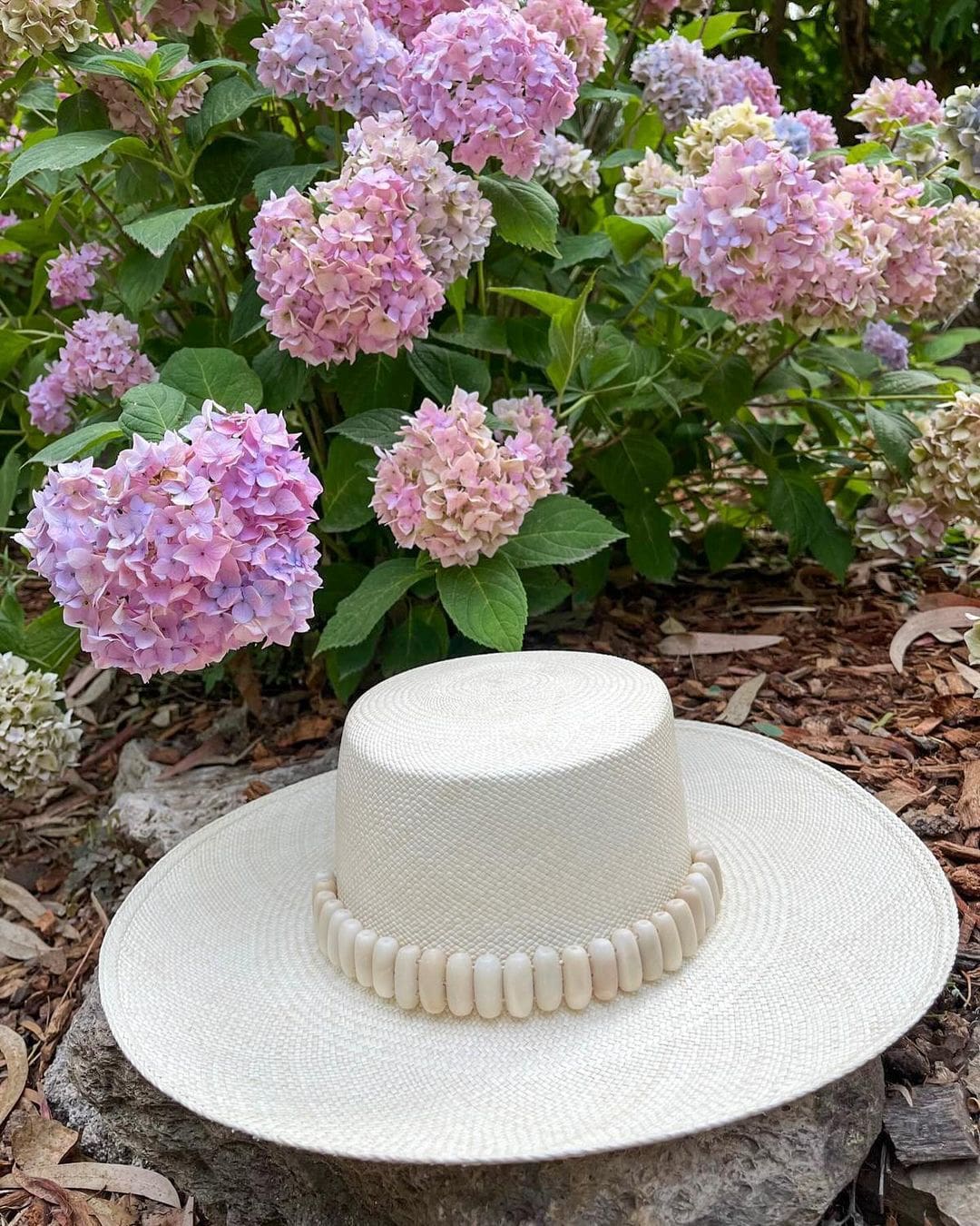 Wide-brimmed straw hat adorned with tagua nut beads in the Raku - Wide Brim product