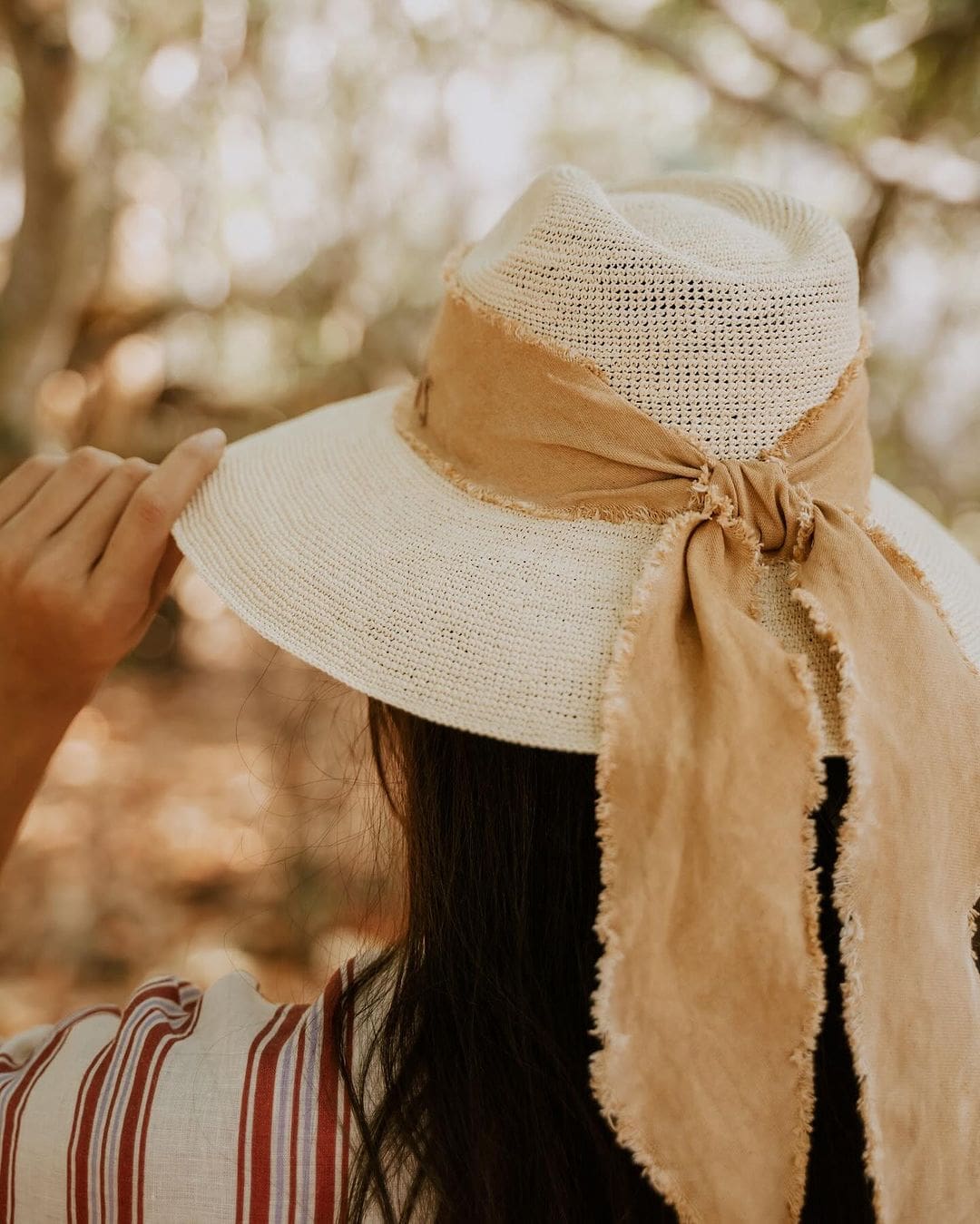 Straw hat with tan ribbon made from toquilla straw, featuring custom initials design