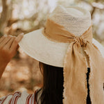 Straw hat with tan ribbon made from toquilla straw, featuring custom initials design