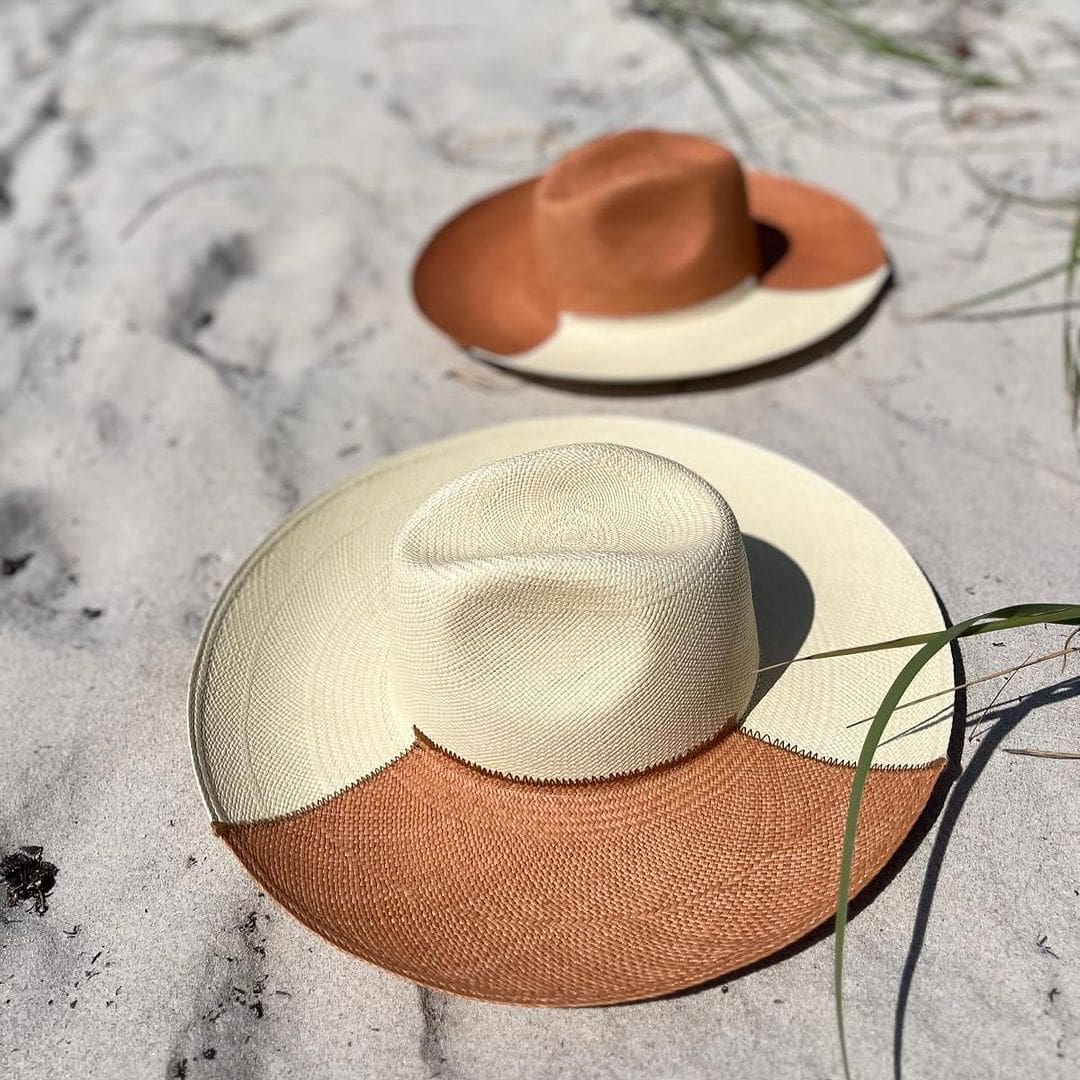 Two-toned straw hats named Cassis, featuring ethically handcrafted Toquilla straw