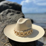 Beige toquilla straw hat with wooden band, ethically handcrafted and stylish for any occasion
