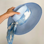 Light blue toquilla straw sun hat with cloud-patterned scarf and custom initials