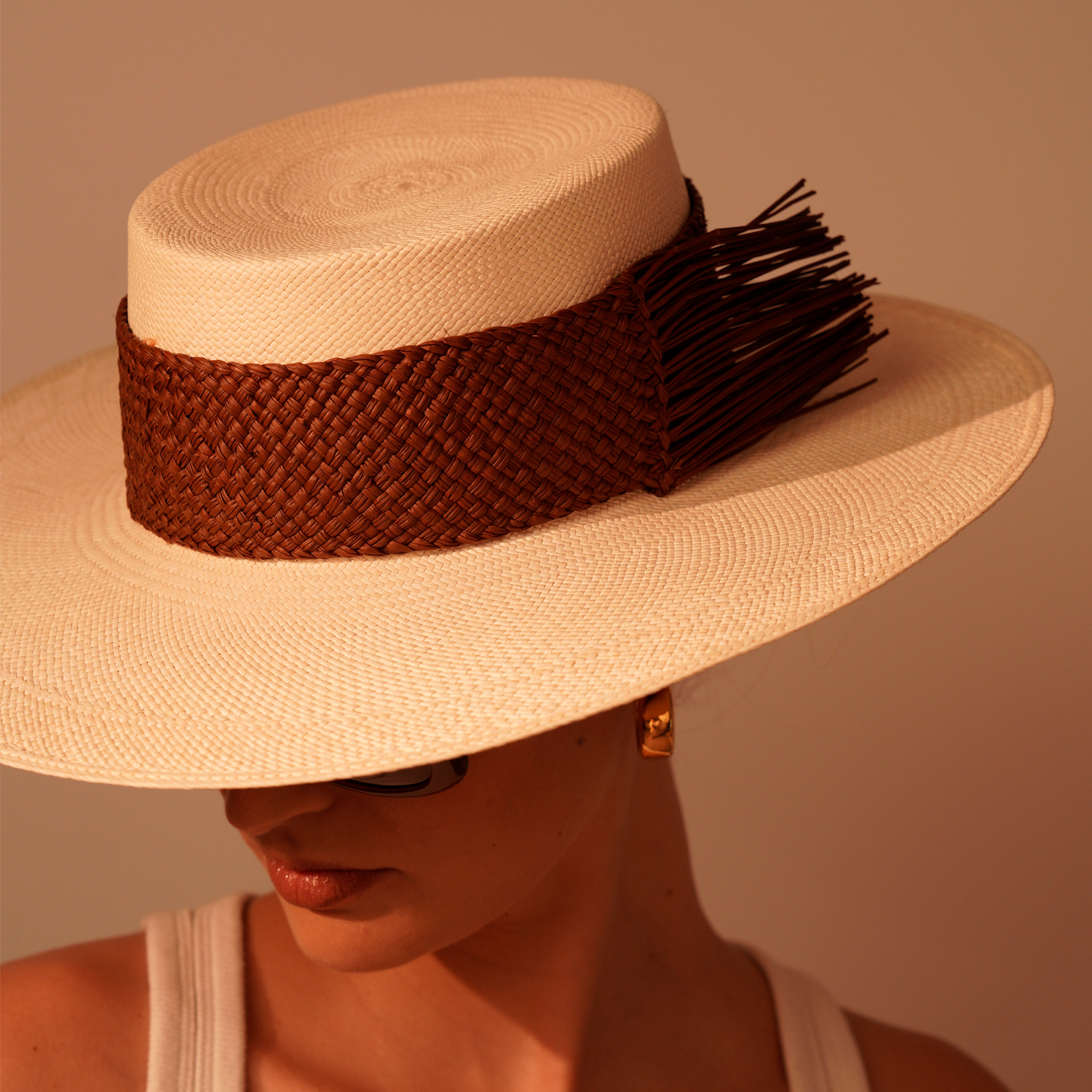 Wide-brimmed Caracara toquilla straw hat with brown woven band made from sustainable materials