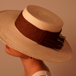 Wide-brimmed Caracara hat made from toquilla straw with brown woven band and fringe