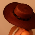Brown wide-brimmed hat made of natural toquilla straw with beaded tagua nut band