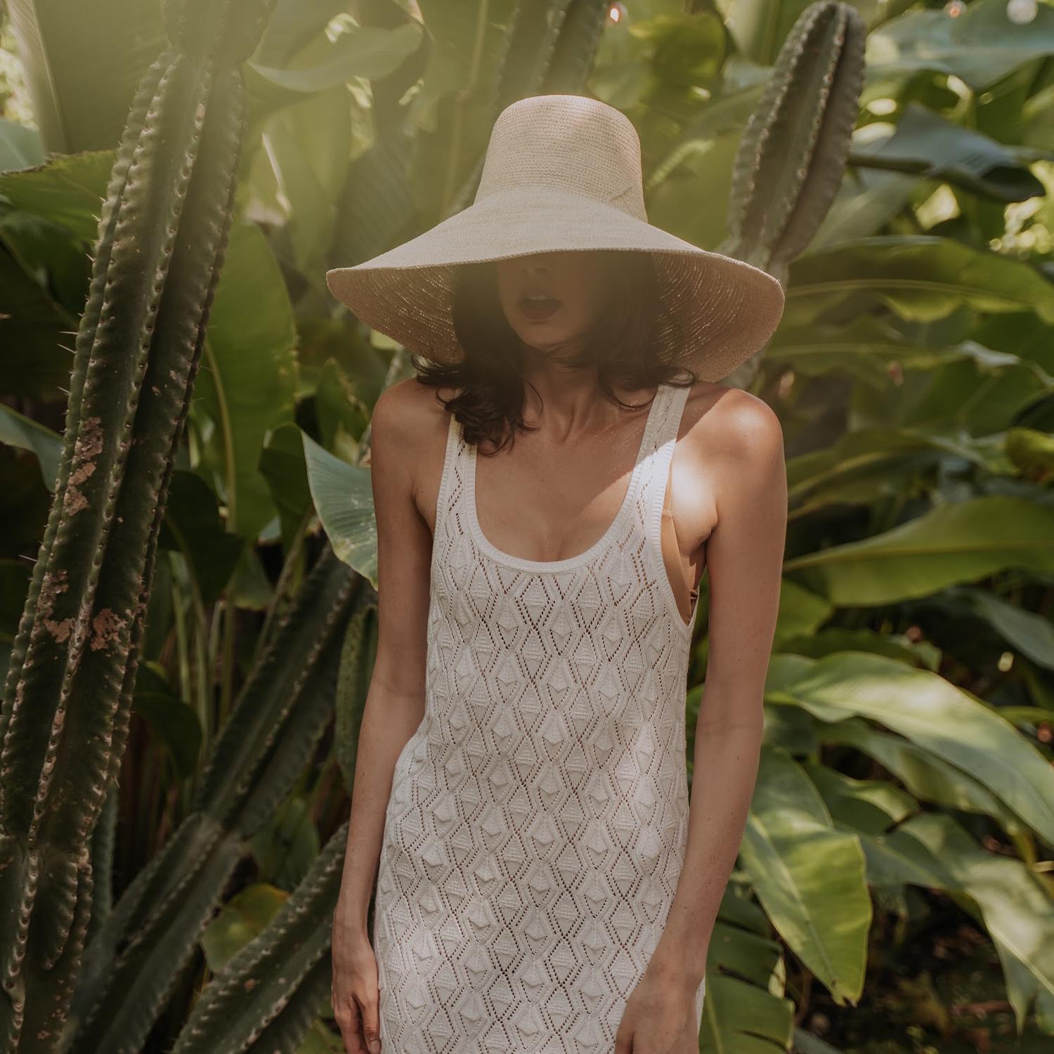 Woman wearing a crocheted dress and Verona Extra Wide Brim Packable sun hat