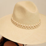Wide-brimmed straw hat made of natural toquilla straw with a stylish beaded band