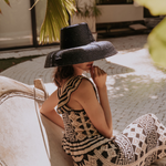 Wide-brimmed black straw hat made of natural mocora straw for stylish sun protection