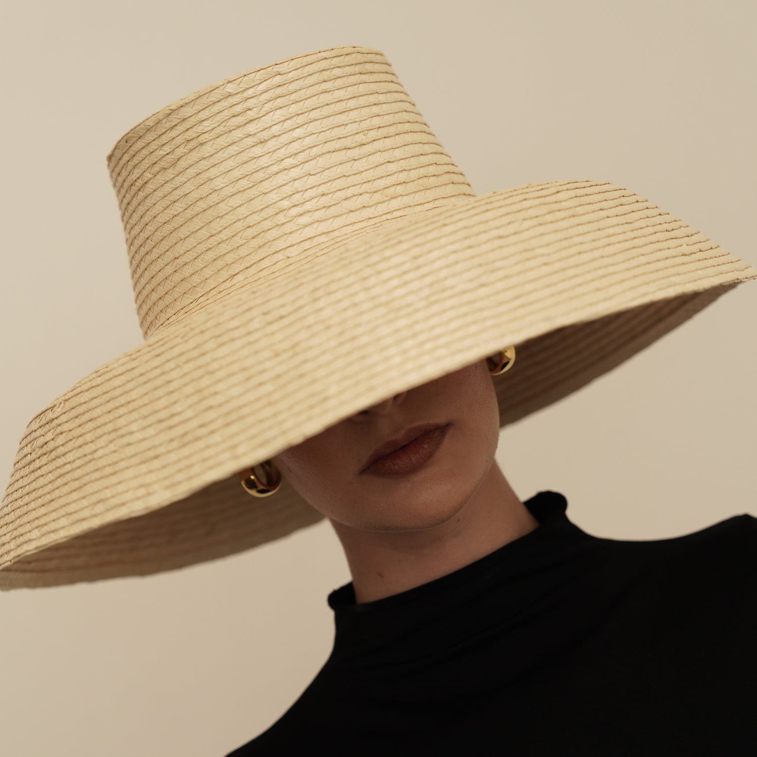 Wide-brimmed straw hat made from natural mocora straw, perfect for Bali beach days