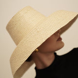 Wide-brimmed straw sun hat made from natural mocora straw, perfect for sunny days