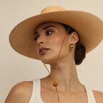 Wide-brimmed straw hat made from natural toquilla straw with a chin strap, Bromelia product