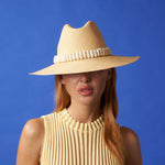 Woman in a Shayak Wide Brim hat made of toquilla straw and adorned with tagua nut