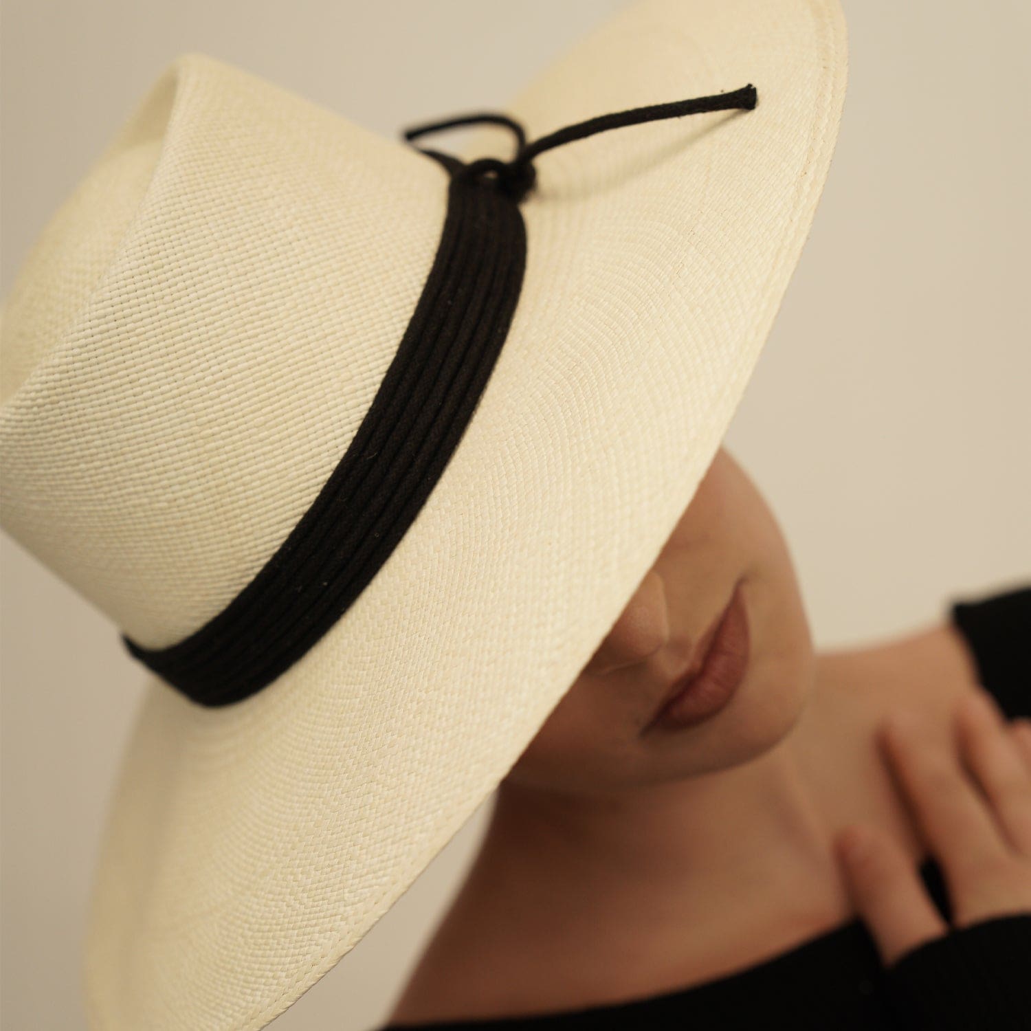 Wide-brimmed straw hat with black band, a Genuine Panama Hat in Toquilla Straw style