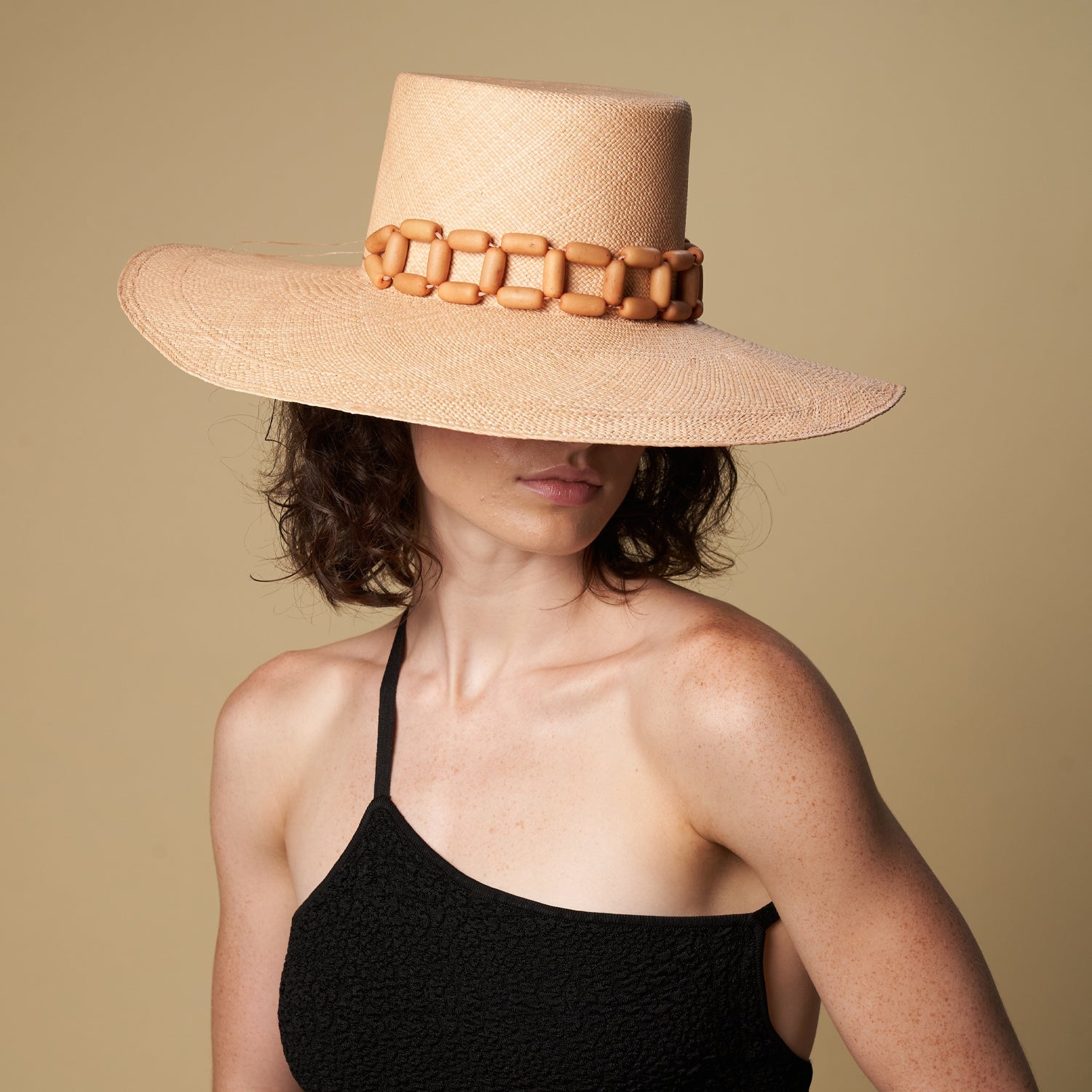 Wide-brimmed straw hat with wooden bead band, an ethically handcrafted Genuine Panama Hat